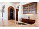 Wet bar featuring a sink, custom cabinetry, and a wine cellar at 13141 E Cibola Rd, Scottsdale, AZ 85259
