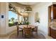 Charming dining area with a view of the outdoor patio and landscaped backyard at 13141 E Cibola Rd, Scottsdale, AZ 85259