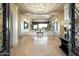 Grand foyer with travertine floors, large windows, and an open layout to the main living spaces at 13141 E Cibola Rd, Scottsdale, AZ 85259