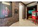 Hallway entrance to home theater room with custom brick and movie theme decor at 13141 E Cibola Rd, Scottsdale, AZ 85259