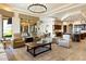 Spacious living area with comfortable seating, a chandelier, and seamless access to the kitchen at 13141 E Cibola Rd, Scottsdale, AZ 85259