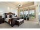 Spacious main bedroom featuring tray ceilings, plantation shutters, and a private balcony to enjoy at 13141 E Cibola Rd, Scottsdale, AZ 85259