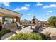 Outdoor space featuring an outdoor kitchen, fireplace, seating area with mountain views in the background at 13141 E Cibola Rd, Scottsdale, AZ 85259