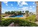 Beautiful pool area with a rock waterfall, lush greenery, and comfortable lounge chairs at 13141 E Cibola Rd, Scottsdale, AZ 85259