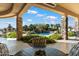 Covered outdoor space featuring brick columns and a view of the pool, landscaping, and desert scenery at 13141 E Cibola Rd, Scottsdale, AZ 85259