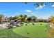 Enjoy outdoor living on the putting green, surrounded by lush landscaping and a rock waterfall pool at 13141 E Cibola Rd, Scottsdale, AZ 85259