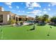 Entertain friends with this lush putting green, landscaping, and waterfall pool feature at 13141 E Cibola Rd, Scottsdale, AZ 85259