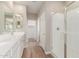 Well-lit bathroom offers a long vanity with white cabinets and a modern glass-enclosed shower at 4924 W Beryl Ave, Glendale, AZ 85302