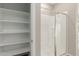 View of bathroom shower with glass door and a walk in closet with shelves at 4924 W Beryl Ave, Glendale, AZ 85302