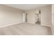 Spacious bedroom boasts neutral walls and soft carpet, leading to a bathroom and staircase at 4924 W Beryl Ave, Glendale, AZ 85302