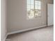 Bright bedroom with neutral carpet, large window, and white door at 4924 W Beryl Ave, Glendale, AZ 85302