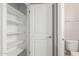 View of walk-in closet with white shelving, bathroom with toilet and shower at 4924 W Beryl Ave, Glendale, AZ 85302