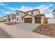 Charming two-story home featuring a terracotta roof, stucco siding, blue shutters, and a spacious three-car garage at 4924 W Beryl Ave, Glendale, AZ 85302
