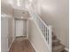 Bright foyer boasts wood-look floors, a staircase with white railing, and a large front door for a welcoming entrance at 4924 W Beryl Ave, Glendale, AZ 85302