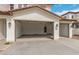 Attached three-car garage with automatic doors, exterior lighting, and a concrete driveway offer convenient parking at 4924 W Beryl Ave, Glendale, AZ 85302