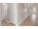 Neutral hallway with hardwood floors, natural lighting, and a staircase creates an inviting transitional space at 4924 W Beryl Ave, Glendale, AZ 85302