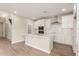 Modern kitchen boasts white cabinets, quartz countertops, stainless steel appliances, and an island with a sink at 4924 W Beryl Ave, Glendale, AZ 85302