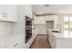 Well-equipped kitchen features quartz countertops, white cabinets, stainless steel appliances, and a double oven at 4924 W Beryl Ave, Glendale, AZ 85302