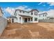 Large backyard with white stucco house and covered patio, showcasing the potential for outdoor living at 4925 W Beryl Ave, Glendale, AZ 85302