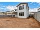 View of the home's rear elevation and empty backyard, highlighting its stucco exterior and covered patio at 4925 W Beryl Ave, Glendale, AZ 85302