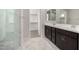 Bathroom with marble flooring, double vanity, glass shower, and walk-in closet at 4925 W Beryl Ave, Glendale, AZ 85302