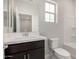 Bathroom featuring modern vanity, window, toilet, and bathtub-shower combo at 4925 W Beryl Ave, Glendale, AZ 85302