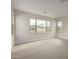 Bright, empty room with neutral carpeting and paint, and a view of community homes at 4925 W Beryl Ave, Glendale, AZ 85302