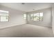 Bright bedroom with neutral carpet and paint with views of community homes at 4925 W Beryl Ave, Glendale, AZ 85302
