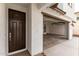 Inviting front entry view of a garage and modern design details and a brown front door at 4925 W Beryl Ave, Glendale, AZ 85302