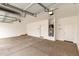 Spacious two-car garage with concrete flooring and overhead lighting at 4925 W Beryl Ave, Glendale, AZ 85302