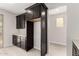 Kitchen area with dark wood cabinets, countertop, and space for built in fridge and wine cooler at 4925 W Beryl Ave, Glendale, AZ 85302