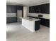 Modern kitchen with island, dark cabinetry, tile backsplash, and stainless appliances at 4925 W Beryl Ave, Glendale, AZ 85302