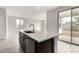 Kitchen island with stainless steel dishwasher and sink, and large sliding doors in background at 4925 W Beryl Ave, Glendale, AZ 85302