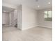 Bright living room features tile flooring, neutral walls, and a window for natural light at 4925 W Beryl Ave, Glendale, AZ 85302