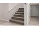 Carpeted staircase with modern white banister and gray walls leading to the upper level at 4925 W Beryl Ave, Glendale, AZ 85302
