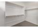 Bright walk-in closet featuring built-in shelving, providing ample storage space at 4925 W Beryl Ave, Glendale, AZ 85302