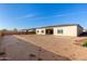 Large backyard with sandy terrain, ready for landscaping and personal touches at 18849 E Azalea Dr, Queen Creek, AZ 85142