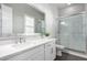 Bathroom with white vanity, quartz countertop, and a glass shower at 18849 E Azalea Dr, Queen Creek, AZ 85142