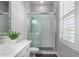 Bathroom with white vanity, quartz countertop, and a glass shower at 18849 E Azalea Dr, Queen Creek, AZ 85142