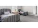 Two twin beds in a well-lit bedroom with gray carpeting and ensuite bath at 18849 E Azalea Dr, Queen Creek, AZ 85142