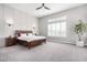 Spacious bedroom with wood bed frame and ample natural light at 18849 E Azalea Dr, Queen Creek, AZ 85142
