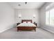 Main bedroom with wood bed frame, window with shutters, and wall sconces at 18849 E Azalea Dr, Queen Creek, AZ 85142