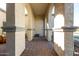 Covered patio area with brick flooring and arched columns at 18849 E Azalea Dr, Queen Creek, AZ 85142
