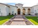 Home's entrance featuring arched entryway and brick walkway at 18849 E Azalea Dr, Queen Creek, AZ 85142