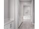 Clean hallway with white cabinets and wood-look flooring at 18849 E Azalea Dr, Queen Creek, AZ 85142