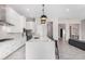 Modern kitchen with white cabinets, large island, and stainless steel appliances at 18849 E Azalea Dr, Queen Creek, AZ 85142