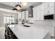Bright kitchen featuring white cabinets, expansive island, and high-end appliances at 18849 E Azalea Dr, Queen Creek, AZ 85142