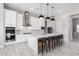 Elegant kitchen with white cabinets, large island, and stainless steel appliances at 18849 E Azalea Dr, Queen Creek, AZ 85142
