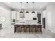 Modern kitchen with white cabinets, large island, and pendant lighting at 18849 E Azalea Dr, Queen Creek, AZ 85142
