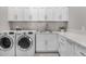 Bright laundry room, featuring white shaker cabinets, quartz countertops, and LG washer/dryer at 18849 E Azalea Dr, Queen Creek, AZ 85142